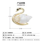 Elegant mother of pearl swan brooch wholesale featuring a carved natural shell wing, pavé cubic zirconia feathers, a black CZ eye, and a magnetic closure from junejewelry.com