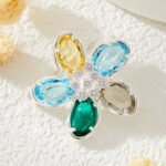 Colorful five-petal flower brooch pin wholesale featuring oval-cut cubic zirconia crystal petals with a micro-pave CZ centerpiece from junejewelry.com