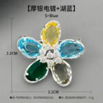 Colorful five-petal flower brooch pin wholesale featuring oval-cut cubic zirconia crystal petals with a micro-pave CZ centerpiece from junejewelry.com