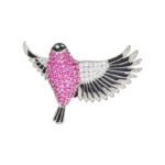 Flying bird crystal brooch wholesale featuring pavé ruby pink cubic zirconia body, clear CZ inner wings, and black enamel feather trim from junejewelry.com