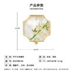 Oriental vintage Chinese style mother of pearl bamboo brooch wholesale featuring a scalloped natural white shell base overlaid with green enamel bamboo stalk, leaves, cubic zirconia accent, and freshwater pearl in gold or silver finish from junejewelry.com