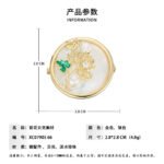 Chinese style enamel chrysanthemum pearl brooch wholesale featuring a circular natural mother of pearl disc, delicate wirework chrysanthemum with green enamel leaf, cubic zirconia sparkles, and a freshwater pearl from junejewelry.com