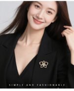 Light luxury hollow flower CZ brooch wholesale featuring pave cubic zirconia openwork petals, 14K gold or platinum color plating, and a large central teardrop pear-cut stone from junejewelry.com