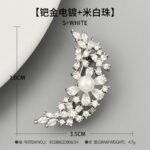 Delicate crescent moon pearl crystal brooch wholesale featuring a sweeping crescent arc encrusted with marquise and pear-cut cubic zirconia floral clusters centered around a smooth pearl accent from junejewelry.com
