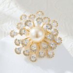 Luxurious pearl floral crystal brooch wholesale featuring a large center pearl surrounded by radiating wire-set pear-cut cubic zirconia petals from junejewelry.com