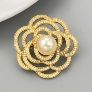 Elegant camellia flower pearl brooch wholesale featuring layered hollow micro-pave cubic zirconia petals centered with a round gray, white, or champagne glass pearl from junejewelry.com