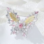 Elegant butterfly shell crystal brooch wholesale featuring carved natural shell inner wings framed by marquise cubic zirconia crystal clusters and a convertible dual-hook back pin from junejewelry.com