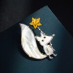 Cute fox star brooch wholesale featuring mother of pearl shell body and tail inlay, holding a yellow crystal star wand with cubic zirconia nose detail from junejewelry.com