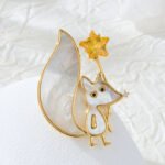 Cute fox star brooch wholesale featuring mother of pearl shell body and tail inlay, holding a yellow crystal star wand with cubic zirconia nose detail from junejewelry.com