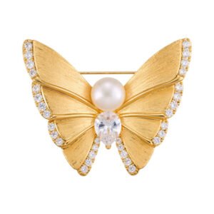 Textured butterfly pearl brooch wholesale featuring brushed matte gold wings trimmed with pavé cubic zirconia crystals, a sparkling heart-cut CZ center stone, a freshwater pearl body, and a convertible back hook from junejewelry.com
