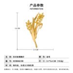 Elegant golden wheat ear CZ brooch wholesale featuring brushed matte gold leaves and marquise-cut yellow cubic zirconia wheat grains on a gold-plated setting from junejewelry.com