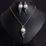 Niche pearl crystal vine jewelry set wholesale featuring a lustrous synthetic pearl encircled by an asymmetric marquise crystal vine motif with matching drop earrings from junejewelry.com