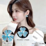 Wholesale turquoise pave earrings collection featuring micro-pave turquoise studs, huggie hoops, pearl drops, swan, and flower designs.
