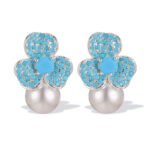 Wholesale turquoise pave earrings collection featuring micro-pave turquoise studs, huggie hoops, pearl drops, swan, and flower designs.
