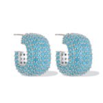Wholesale turquoise pave earrings collection featuring micro-pave turquoise studs, huggie hoops, pearl drops, swan, and flower designs.