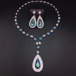 Silver statement necklace and drop earrings jewelry set with teardrop Swarovski Element crystals and pave halo wholesale
