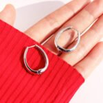 Wholesale modern waterdrop oval huggie hoop earrings with genuine 18K gold and white gold plating on copper