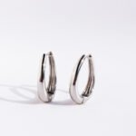 Wholesale modern waterdrop oval huggie hoop earrings with genuine 18K gold and white gold plating on copper