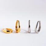 Wholesale modern waterdrop oval huggie hoop earrings with genuine 18K gold and white gold plating on copper