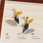 Wholesale modern two-tone asymmetric heart dangle earrings with genuine 18K gold and white gold plating on copper