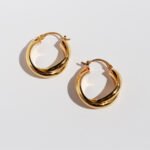 Wholesale modern twisted crossover intertwined hoop earrings with genuine 18K gold and white gold plating on copper