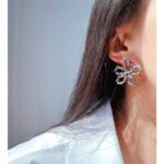 Wholesale modern beaded disc cutout floral stud earrings with genuine 18K gold and white gold plating on copper