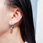 Wholesale modern sculptural twisted wave huggie hoop earrings with genuine 18K gold and white gold plating on copper