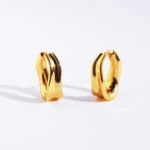 Wholesale modern sculptural twisted wave huggie hoop earrings with genuine 18K gold and white gold plating on copper