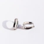 Wholesale modern sculptural twisted wave huggie hoop earrings with genuine 18K gold and white gold plating on copper