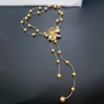 Shell pearl floral necklace wholesale featuring 18k gold plated dual chain strand with station shell pearls, 3D micro pave cz lily flower adjustable slide clasp, and dangling tassel ends.