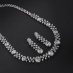 Oval crystal jewelry set wholesale featuring large oval halo cut crystals linked with marquise leaf accents on a statement collar necklace with matching long dangle drop earrings on palladium plated copper.