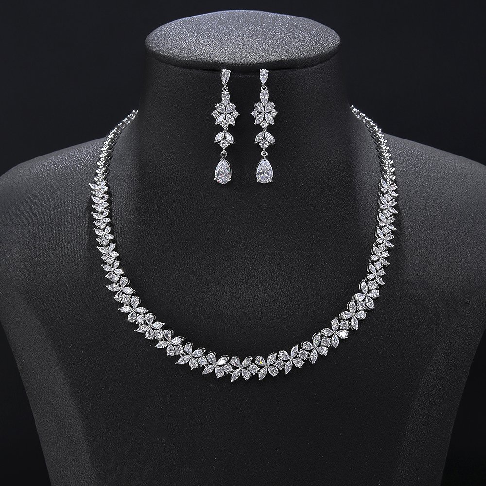 CN11199.450.A Floral crystal jewelry set wholesale featuring continuous four-petal flower stations necklace with sparkling marquise crystals and matching teardrop dangle earrings on palladium plated copper.