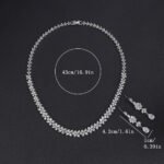 Floral crystal jewelry set wholesale featuring continuous four-petal flower stations necklace with sparkling marquise crystals and matching teardrop dangle earrings on palladium plated copper.