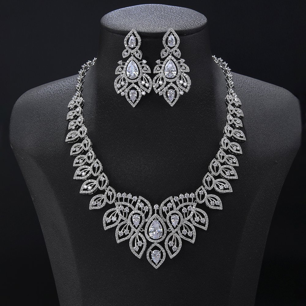 CN11226.784.A Crown crystal jewelry set wholesale featuring ornate filigree teardrop halo bib collar necklace with large pear cut crystal center and matching chandelier earrings on palladium plated copper base.