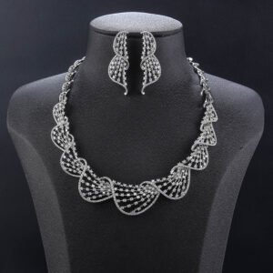 Wave mesh crystal jewelry set wholesale featuring overlapping scalloped ocean wave lattice collar necklace with pave round crystals and matching drop earrings on palladium plated copper.