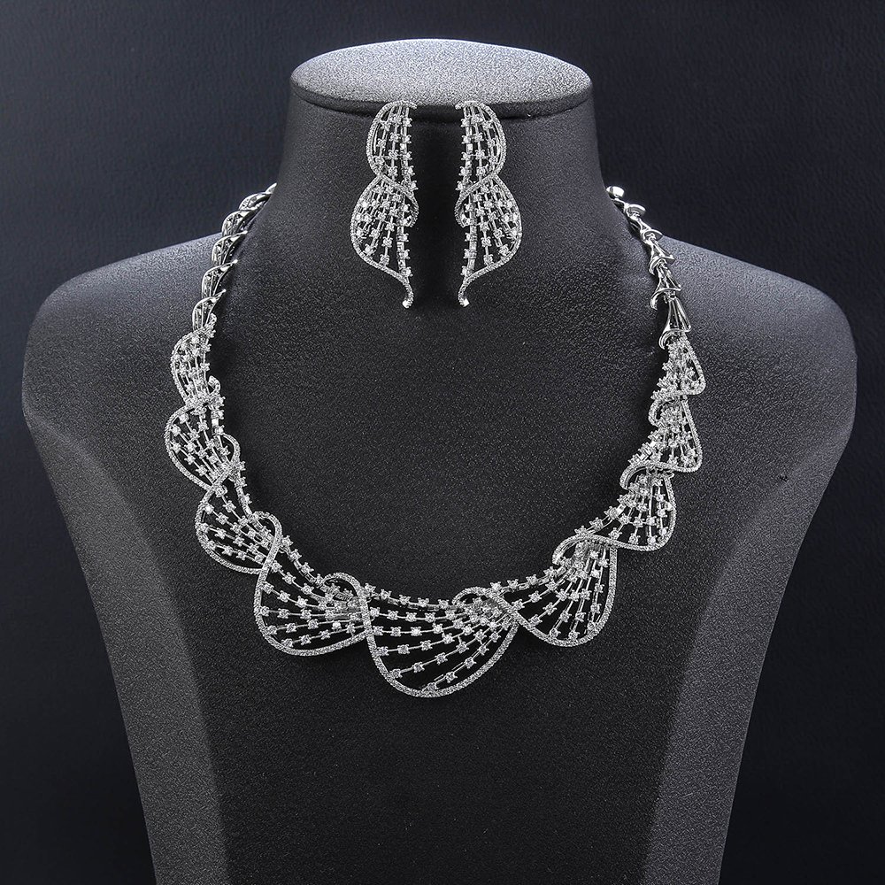 Wave mesh crystal jewelry set wholesale featuring overlapping scalloped ocean wave lattice collar necklace with pave round crystals and matching drop earrings on palladium plated copper.