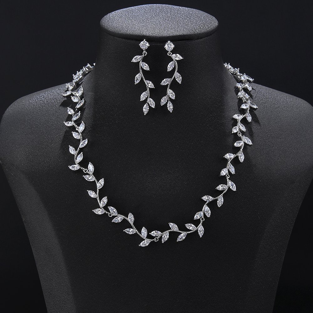 Leaf vine crystal jewelry set wholesale featuring delicate organic olive branch collar necklace with marquise cut crystal leaves and matching dangling drop earrings on palladium plated copper base.