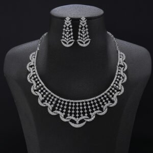 Crescent crystal jewelry set wholesale featuring a curved lattice mesh collar necklace edged with micro-pave crescent moon arches and matching drop earrings on palladium plated copper.