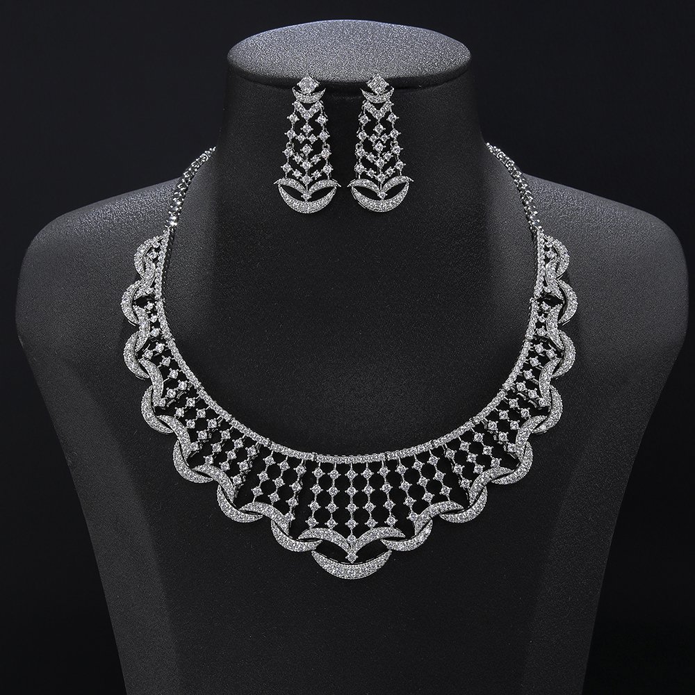 Crescent crystal jewelry set wholesale featuring a curved lattice mesh collar necklace edged with micro-pave crescent moon arches and matching drop earrings on palladium plated copper.