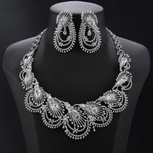 Peacock crystal jewelry set wholesale featuring radial peacock feather fan collar necklace with marquise cut main crystals, layered arc drop fringe, and matching dangle earrings on palladium plated copper.