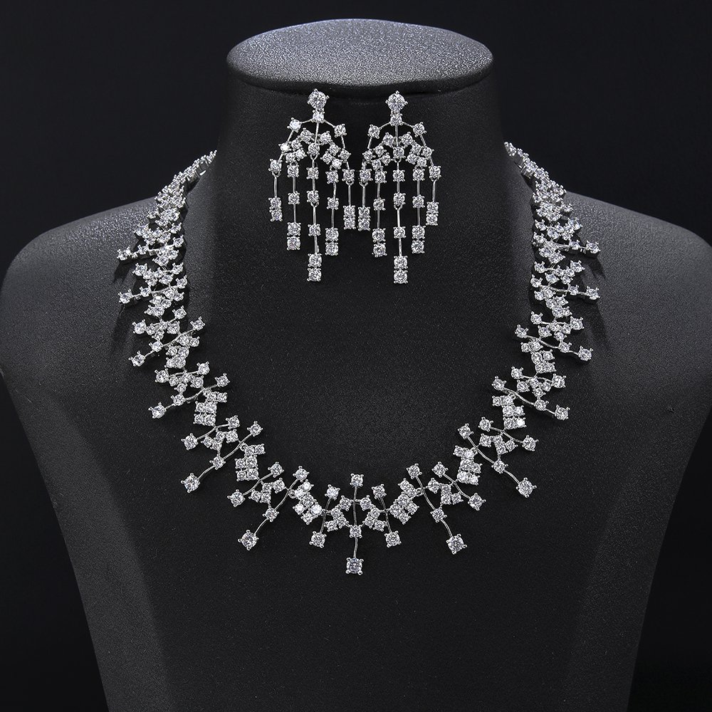 Cascade crystal jewelry set wholesale featuring staggered geometric crystal lattice collar necklace with vertical pin drop tassels and matching chandelier earrings on palladium plated copper.