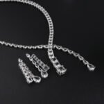 Y lariat crystal jewelry set wholesale featuring asymmetric emerald cut and pear cut crystal lariat necklace with dangling stream drop and matching earrings on palladium plated copper.