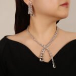 Y lariat crystal jewelry set wholesale featuring asymmetric emerald cut and pear cut crystal lariat necklace with dangling stream drop and matching earrings on palladium plated copper.