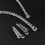 Lariat drop crystal jewelry set wholesale featuring modern asymmetric emerald cut and teardrop crystal lariat strand necklace with dual dangling streamers and matching earrings on palladium plated copper.