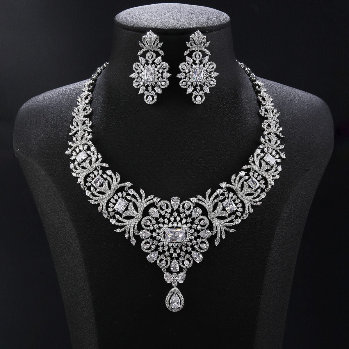 Royal medallion crystal jewelry set wholesale featuring ornate baroque lace medallion collar necklace with center rectangular crystal gem, hanging teardrop pendant, and matching chandelier drop earrings on palladium plated copper.