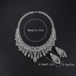 Crown lace crystal jewelry set wholesale featuring regal tiara arch openwork collar necklace with branching floral tassels and matching chandelier earrings on palladium plated copper.