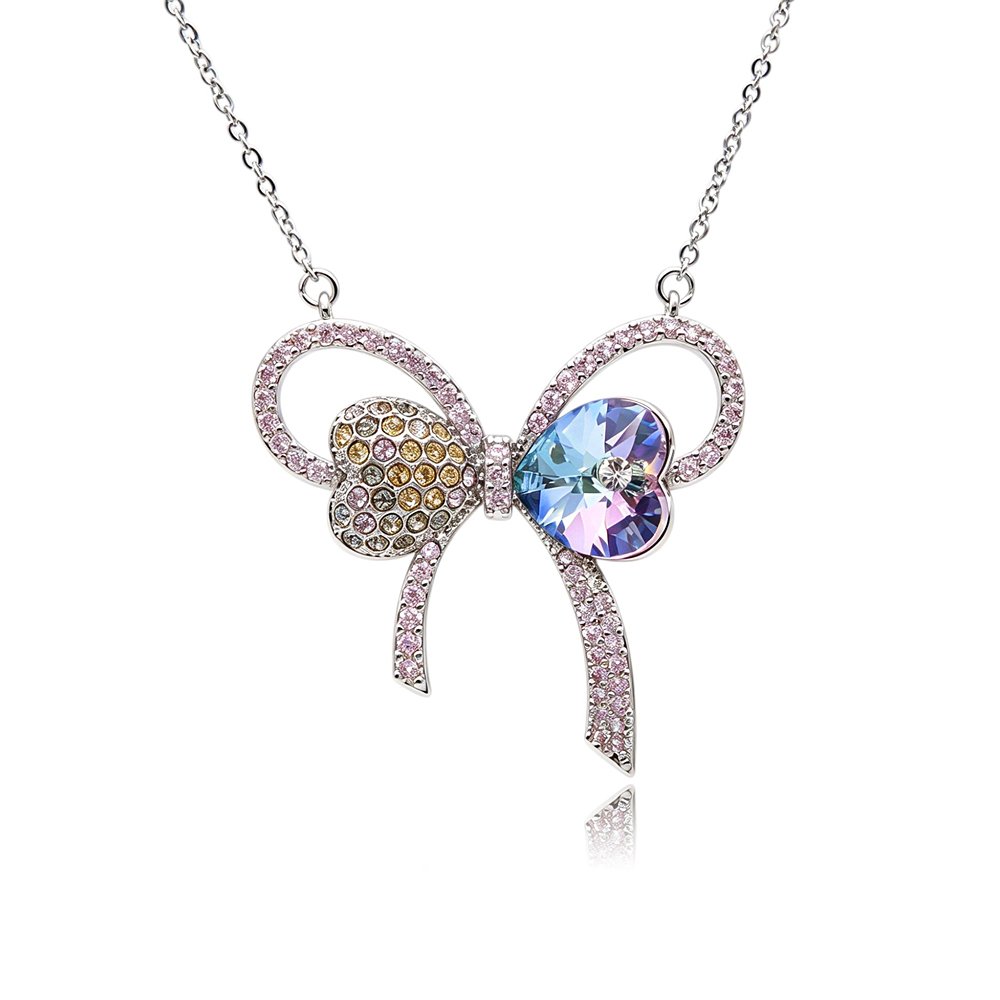 Silver bow pendant necklace with pavé ribbons, heart-shaped crystal, and multi-colored pave accents wholesale