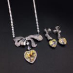 Silver tennis necklace and drop earrings set with pave bow and heart cut Swarovski Element crystals wholesale