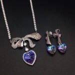 Silver tennis necklace and drop earrings set with pave bow and heart cut Swarovski Element crystals wholesale