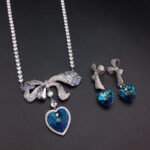 Silver tennis necklace and drop earrings set with pave bow and heart cut Swarovski Element crystals wholesale